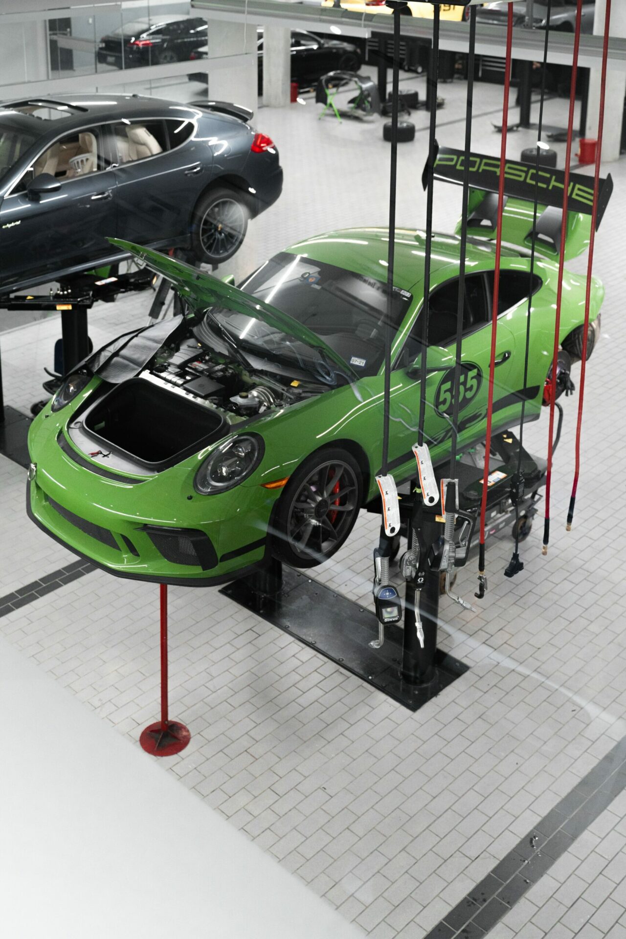 green car on a lifting platform