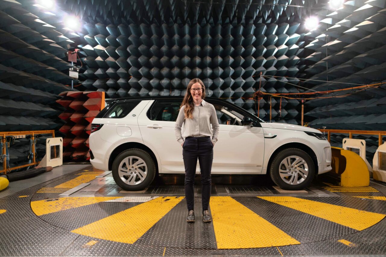 Female electronics engineer in anechoic chamber
